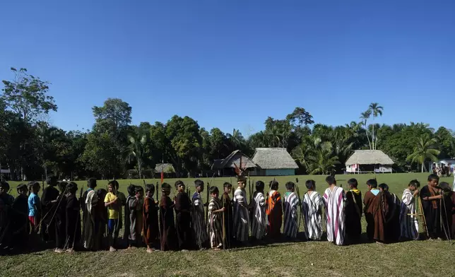 Ashaninka Indigenous children prepare for a bow and arrow competition during the annual celebration recognizing the Ashaninka territory in the Apiwtxa village, Acre state, Brazil, Sunday, June 23, 2024. (AP Photo/Jorge Saenz)