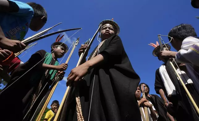 Ashaninka Indigenous children prepare for a bow and arrow competition during the annual celebration recognizing the Ashaninka territory in the Apiwtxa village, Acre state, Brazil, Sunday, June 23, 2024. (AP Photo/Jorge Saenz)