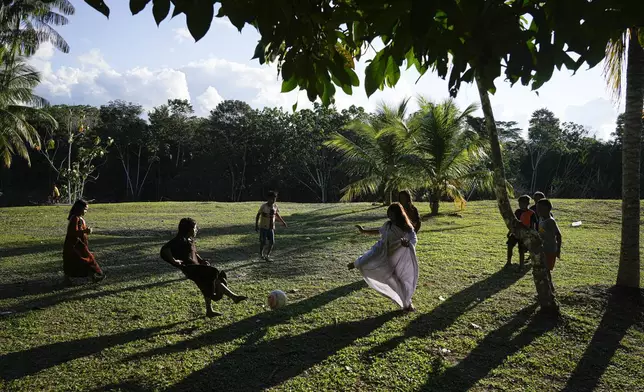 Ashaninka Indigenous children play with a ball in the Apiwtxa village, near Marechal Thaumaturgo city, Acre state, Brazil, Saturday, June 22, 2024. (AP Photo/Jorge Saenz)