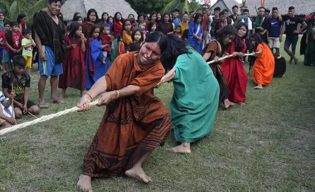 Ashaninka Indigenous women participate in tug-of-war during the annual celebration recognizing the Ashaninka territory in the Apiwtxa village, Acre state, Brazil, Sunday, June 23, 2024. (AP Photo/Jorge Saenz)