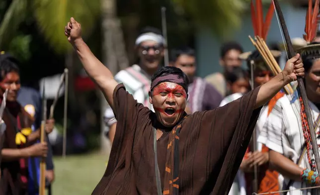 Kamato Ashaninka from Peru reacts to hitting the bullseye in a bow and arrow competition during the annual celebration recognizing the Ashaninka territory in the Apiwtxa village, Acre state, Brazil, Sunday, June 23, 2024. (AP Photo/Jorge Saenz)