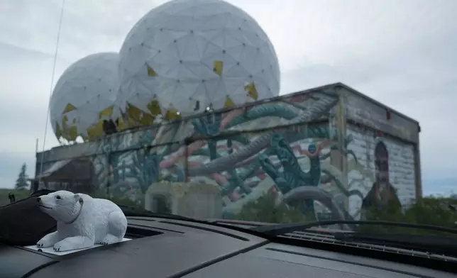 A toy polar bear sits on the dashboard of a truck near an abandoned radar station, Sunday, Aug. 4, 2024, in Churchill, Manitoba. (AP Photo/Joshua A. Bickel)