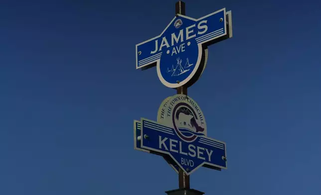 Street signs featuring a polar bear and Indigenous tipis stand on a street corner, Tuesday, Aug. 6, 2024, in Churchill, Manitoba. (AP Photo/Joshua A. Bickel)