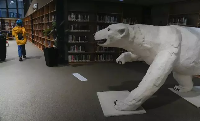 A polar bear sculpture greets patrons, Wednesday, Aug. 7, 2024, at the Churchill Public Library in Churchill, Manitoba. (AP Photo/Joshua A. Bickel)