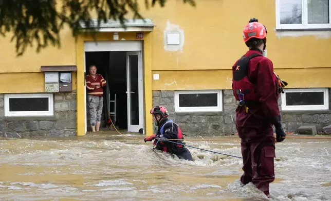 FILE - A resident waits to be evacuated from his flooded house in Jesenik, Czech Republic, Sept. 15, 2024. (AP Photo/Petr David Josek, File)