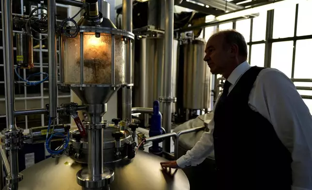 Professor Thomas Becker checks the brewery plant in Freising, Germany, Thursday, Sept. 19, 2024. (AP Photo/Matthias Schrader)