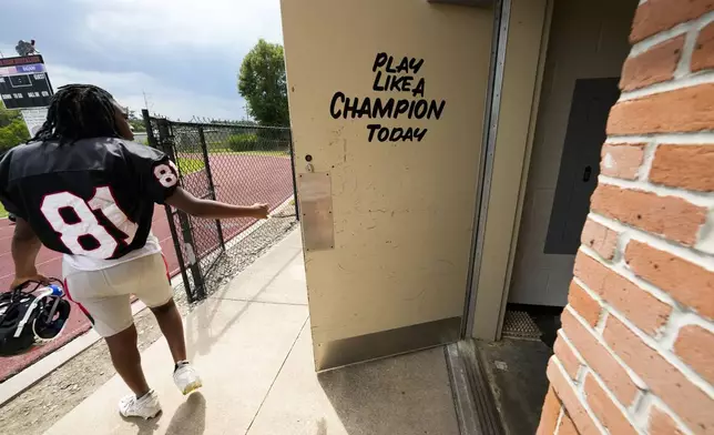 Members of the Baker high football team leave the locker room to take to the field for practice in Baker, La., Wednesday, Aug. 28, 2024. (AP Photo/Gerald Herbert)