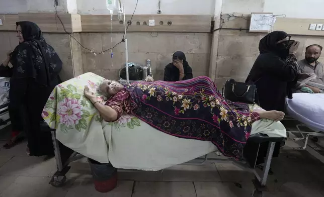 FILE - A patient suffering from heatstroke receives treatment at a hospital in Karachi, Pakistan, June 25, 2024. (AP Photo/Fareed Khan, File)