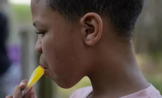 FILE - Zariah Fields eats a popsicle, June 20, 2024, at YMCA Camp Kern in Oregonia, Ohio. (AP Photo/Joshua A. Bickel, File)