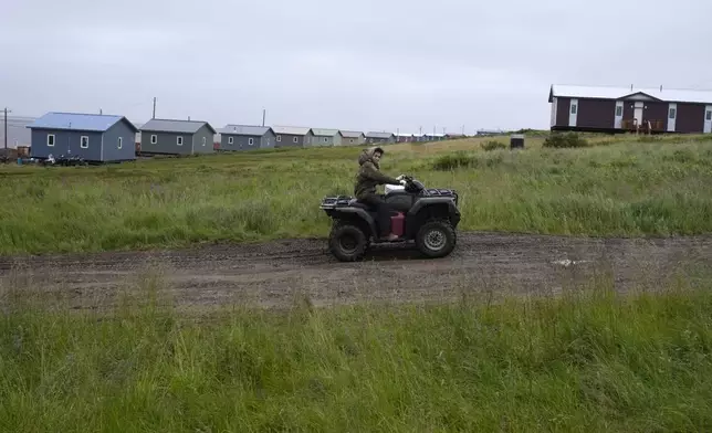 A young man drives an ATV on Friday, Aug. 16, 2024, Mertarvik, Alaska. (AP Photo/Rick Bowmer)