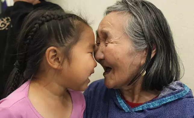 Girlie Carl, 4, plays with her grandmother Marie Carl, 75, on Thursday, Aug. 15, 2024, Mertarvik, Alaska. (AP Photo/Rick Bowmer)