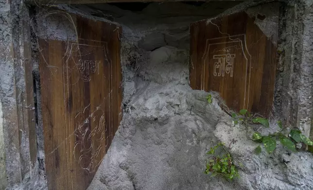 The sand-filled entrance of a house is visible in Chanaute Market, Melamchi, northeast of Kathmandu, Nepal, Sunday, Sept. 15, 2024, that was damaged by floods in 2021. (AP Photo/Niranjan Shrestha)