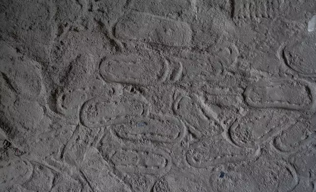 Footprints are visible at Chanaute Market, Melamchi, northeast from Kathmandu, Nepal, Sunday, Sept. 15, 2024, on the sand inside a house damaged by floods in 2021. (AP Photo/Niranjan Shrestha)