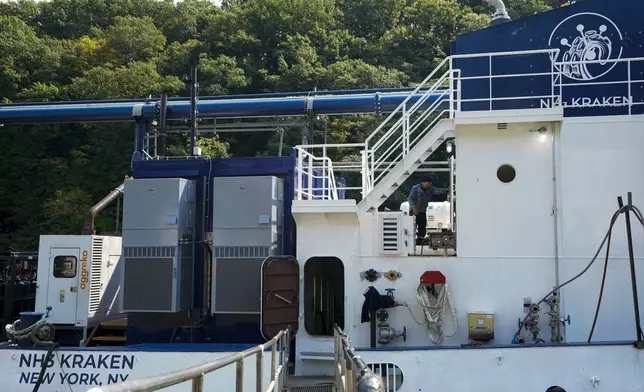 A worker walks on the NH3 Kraken, a tugboat powered by ammonia, Friday, Sept. 13, 2024, in Kingston, N.Y. (AP Photo/Alyssa Goodman)