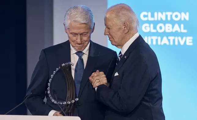 Bill Clinton, founder and board chair of the Clinton Foundation &amp; 42nd President of the United States, left, gives President Joe Biden the "Global Citizen Award" as they clasp hands during the Clinton Global Initiative, on Monday, Sept. 23, 2024, in New York. (AP Photo/Andres Kudacki)