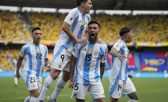 Argentina's Nicolas Gonzalez (15) celebrates scoring his side's first goal against Colombia with teammates during a qualifying soccer match for the FIFA World Cup 2026 at the Metropolitano Roberto Melendez stadium in Barranquilla, Colombia, Tuesday, Sept. 10, 2024. (AP Photo/Fernando Vergara)