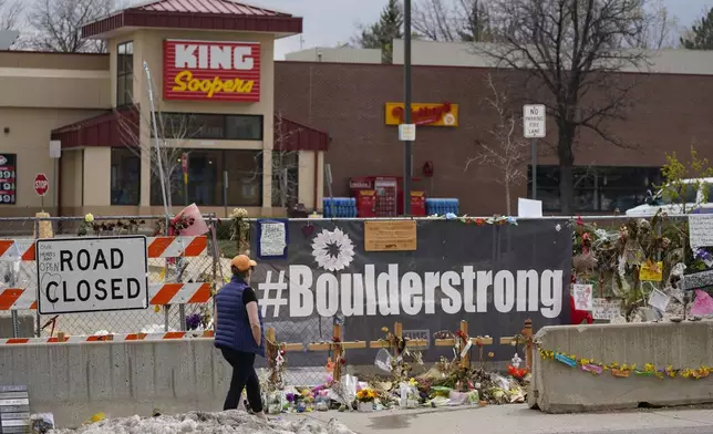 FILE - Tributes cover the temporary fence around the King Soopers grocery store in which 10 people died in a mass shooting in late March on Friday, April 23, 2021, in Boulder, Colo. (AP Photo/David Zalubowski, File)