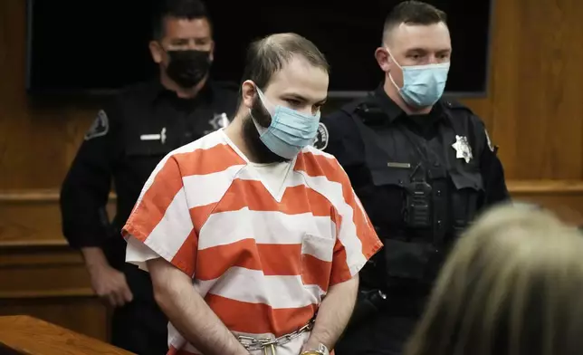 FILE - Ahmad Al Aliwi Alissa, accused of killing 10 people at a Colorado supermarket in March 2021, is led into a courtroom for a hearing, Sept. 7, 2021, in Boulder, Colo. (AP Photo/David Zalubowski, Pool, File)