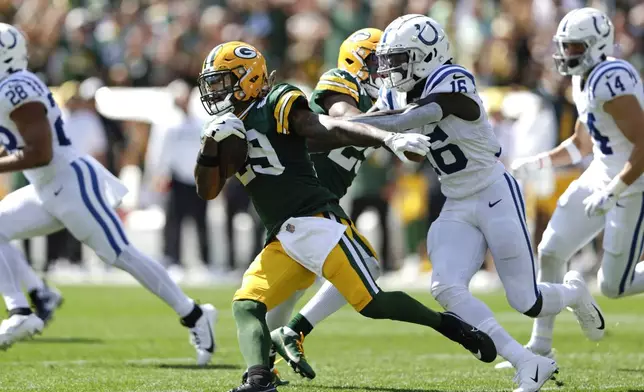 Green Bay Packers safety Xavier McKinney (29) tries to escape from Indianapolis Colts wide receiver Ashton Dulin (16) after an interception during the first half of an NFL football game Sunday, Sept. 15, 2024, in Green Bay, Wis. (AP Photo/Matt Ludtke)