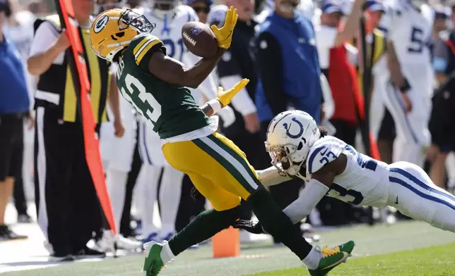 Indianapolis Colts cornerback Kenny Moore II (23) breaks up a pass intended for Green Bay Packers wide receiver Dontayvion Wicks (13) during the first half of an NFL football game Sunday, Sept. 15, 2024, in Green Bay, Wis. (AP Photo/Matt Ludtke)