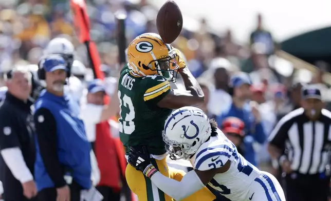 Indianapolis Colts cornerback Kenny Moore II (23) breaks up a pss intended for Green Bay Packers wide receiver Dontayvion Wicks (13) during the first half of an NFL football game Sunday, Sept. 15, 2024, in Green Bay, Wis. (AP Photo/Matt Ludtke)