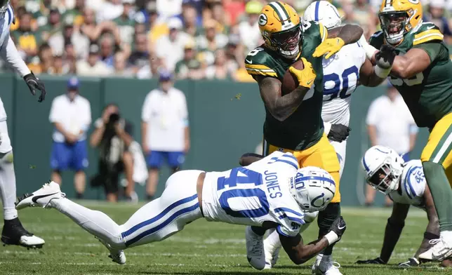 Green Bay Packers running back Josh Jacobs (8) is brought down by Indianapolis Colts cornerback Jaylon Jones (40) during the first half of an NFL football game Sunday, Sept. 15, 2024, in Green Bay, Wis. (AP Photo/Morry Gash)