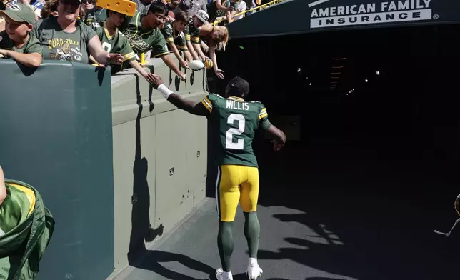 Green Bay Packers quarterback Malik Willis (2) celebrates with fans as he leaves the field after defeating the Indianapolis Colts in an NFL football game Sunday, Sept. 15, 2024, in Green Bay, Wis. (AP Photo/Mike Roemer)