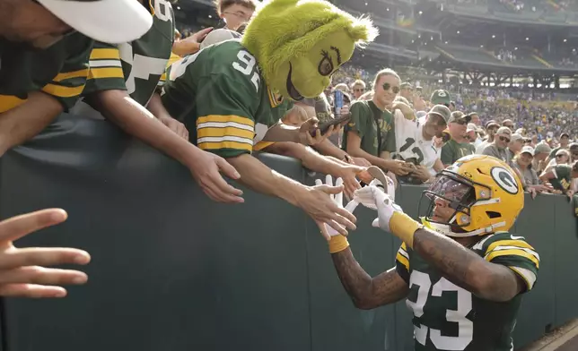 Green Bay Packers cornerback Jaire Alexander (23) greets fans as he leaves the field after defeting Indianapolis Colts in an NFL football game Sunday, Sept. 15, 2024, in Green Bay, Wis. (AP Photo/Mike Roemer)