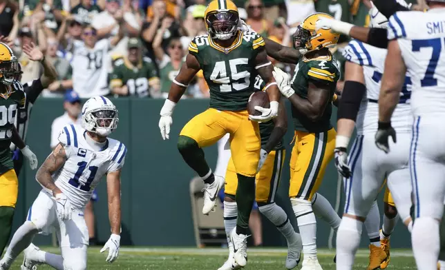 Green Bay Packers linebacker Eric Wilson (45) reacts after intercepting a pass as Indianapolis Colts wide receiver Michael Pittman Jr. (11) looks on during the second half of an NFL football game Sunday, Sept. 15, 2024, in Green Bay, Wis. (AP Photo/Morry Gash)