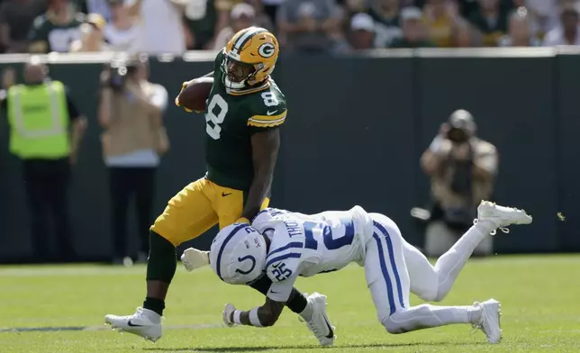 Green Bay Packers running back Josh Jacobs (8) is stopped by Indianapolis Colts safety Rodney Thomas II (25) during the first half of an NFL football game Sunday, Sept. 15, 2024, in Green Bay, Wis. (AP Photo/Matt Ludtke)