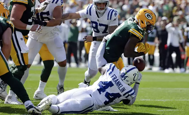 Green Bay Packers running back Josh Jacobs (8) fumbles as he is tackled by Indianapolis Colts linebacker Zaire Franklin (44) during the first half of an NFL football game Sunday, Sept. 15, 2024, in Green Bay, Wis. (AP Photo/Matt Ludtke)