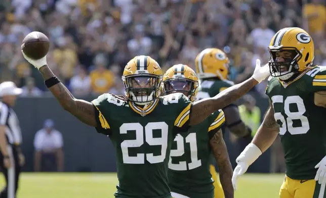 Green Bay Packers safety Xavier McKinney (29) reacts after intercepting a pass during the first half of an NFL football game against the Indianapolis Colts Sunday, Sept. 15, 2024, in Green Bay, Wis. (AP Photo/Mike Roemer)