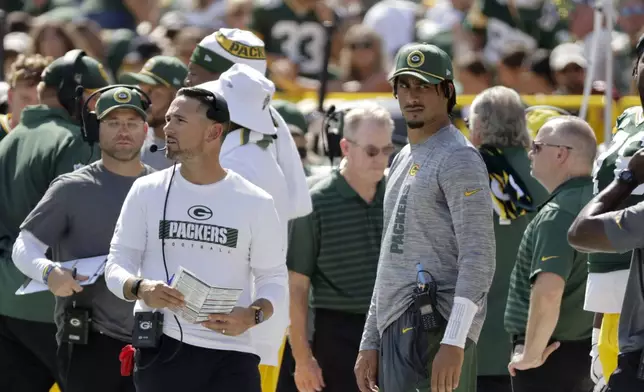 Injured Green Bay Packers quarterback Jordan Love looks on as head coach Matt LaFleur walks by during the first half of an NFL football game against the Indianapolis Colts Sunday, Sept. 15, 2024, in Green Bay, Wis. (AP Photo/Mike Roemer)