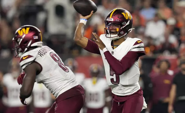 Washington Commanders quarterback Jayden Daniels (5) throws a pass during the first half of an NFL football game against the Cincinnati Bengals, Monday, Sept. 23, 2024, in Cincinnati. (AP Photo/Jeff Dean)