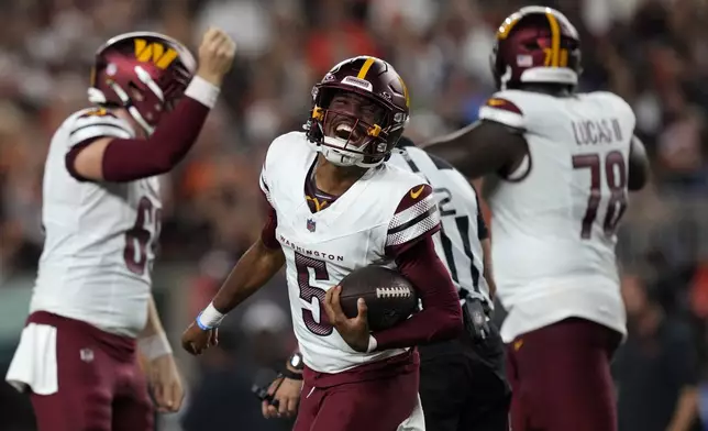 Washington Commanders quarterback Jayden Daniels (5) celebrates after throwing a touchdown pass during the second half of an NFL football game against the Cincinnati Bengals, Monday, Sept. 23, 2024, in Cincinnati. (AP Photo/Carolyn Kaster)