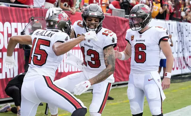 Tampa Bay Buccaneers wide receiver Mike Evans, center, celebrates his touchdown reception with wide receiver Jalen McMillan, left, and quarterback Baker Mayfield (6) during the first half of an NFL football game against the Washington Commanders Sunday, Sept. 8, 2024, in Tampa, Fla. (AP Photo/Chris O'Meara)