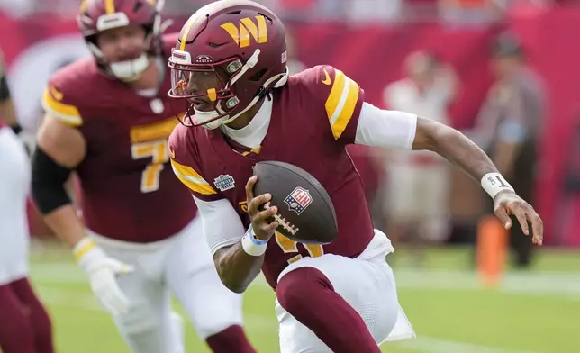 Washington Commanders quarterback Jayden Daniels scrambles against the Tampa Bay Buccaneers during the first half of an NFL football game Sunday, Sept. 8, 2024, in Tampa, Fla. (AP Photo/Chris O'Meara)