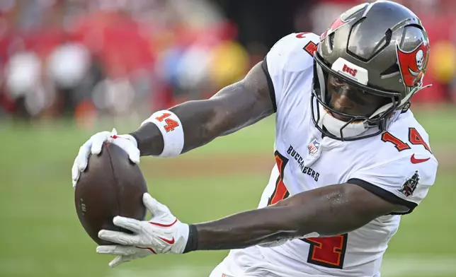 Tampa Bay Buccaneers wide receiver Chris Godwin extends his arms with the ball over the goal line to score a touchdown against the Washington Commanders during the second half of an NFL football game Sunday, Sept. 8, 2024, in Tampa, Fla. (AP Photo/Jason Behnken)