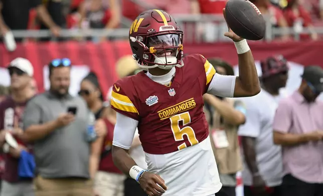 Washington Commanders quarterback Jayden Daniels (5) warms up before an NFL football game against the Tampa Bay Buccaneers Sunday, Sept. 8, 2024, in Tampa, Fla. (AP Photo/Jason Behnken)