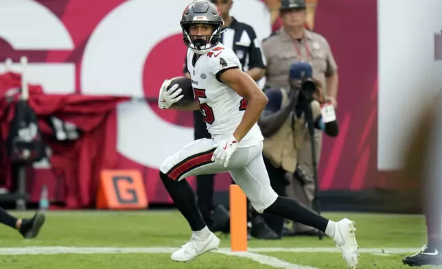 Tampa Bay Buccaneers wide receiver Jalen McMillan crosses the goal line to score a touchdown against the Washington Commanders on a 32-yard pass play during the second half of an NFL football game Sunday, Sept. 8, 2024, in Tampa, Fla. (AP Photo/Chris O'Meara)