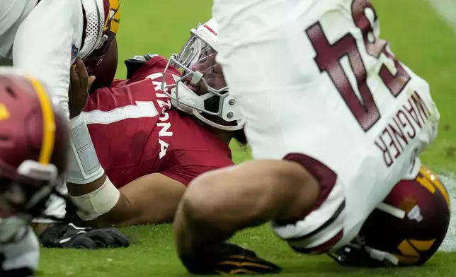 Arizona Cardinals quarterback Kyler Murray (1) is sacked against the Washington Commanders during the first half of an NFL football game, Sunday, Sept. 29, 2024, in Glendale, Ariz. (AP Photo/Ross D. Franklin)