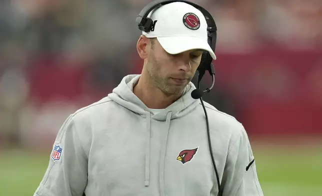 Arizona Cardinals head coach Jonathan Gannon walks the sidelines during the first half of an NFL football game against the Washington Commanders, Sunday, Sept. 29, 2024, in Glendale, Ariz. (AP Photo/Ross D. Franklin)