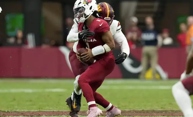 Arizona Cardinals quarterback Kyler Murray (1) is sacked by Washington Commanders defensive end Dorance Armstrong (92) during the first half of an NFL football game, Sunday, Sept. 29, 2024, in Glendale, Ariz. (AP Photo/Ross D. Franklin)