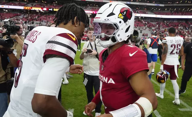 Washington Commanders quarterback Jayden Daniels, left, greets Arizona Cardinals quarterback Kyler Murray after an NFL football game, Sunday, Sept. 29, 2024, in Glendale, Ariz. (AP Photo/Ross D. Franklin)