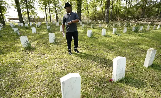 Charles Latham stands among the grave markers in the Confederate cemetery in Grenada, Miss., April 12, 2023. (AP Photo/Rogelio V. Solis)