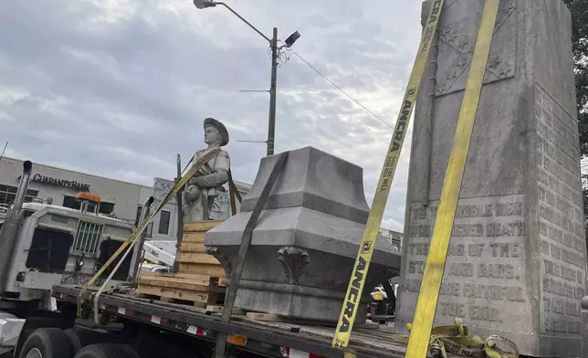 Pieces of a Confederate monument are secured onto a flatbed truck Wednesday, Sept. 11, 2024, after a crew removed them from the spot where the monument had stood since 1910, in downtown Grenada, Miss. (AP Photo/Emily Wagster Pettus)