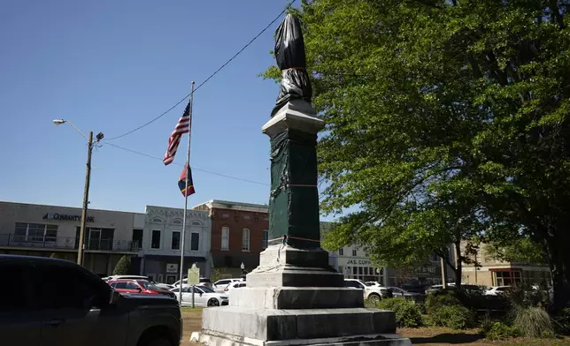 A weather-worn tarp covers the century-old Confederate monument in Grenada, Miss., April 12, 2023. (AP Photo/Rogelio V. Solis)