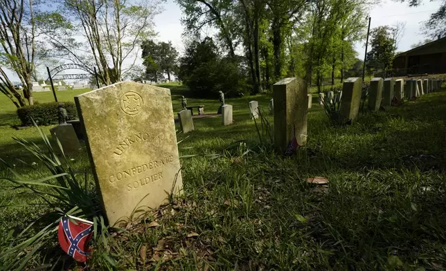 The sun sets on the grave markers in the Confederate cemetery in Grenada, Miss., April 12, 2023. (AP Photo/Rogelio V. Solis)