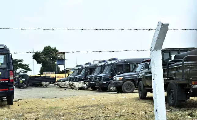 Police vehicles are seen outside the Makala Central prison in Kinshasa, Congo, Tuesday, Sept. 3, 2024 after an attempted jailbreak in Congo’s main prison that left many people dead. (AP Photo/Samy Ntumba Shambuyi)