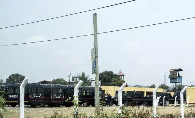 Police vehicles are seen outside the Makala Central prison in Kinshasa, Congo, Tuesday, Sept. 3, 2024 after an attempted jailbreak in Congo’s main prison that left many people dead. (AP Photo/Samy Ntumba Shambuyi)